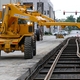 Laying rails on ties, with the steel framework visible underneath